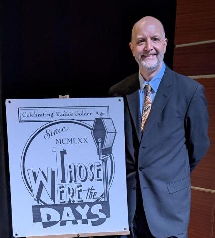 Picture of Steve Darnall next to a board that says "Those were the Days"